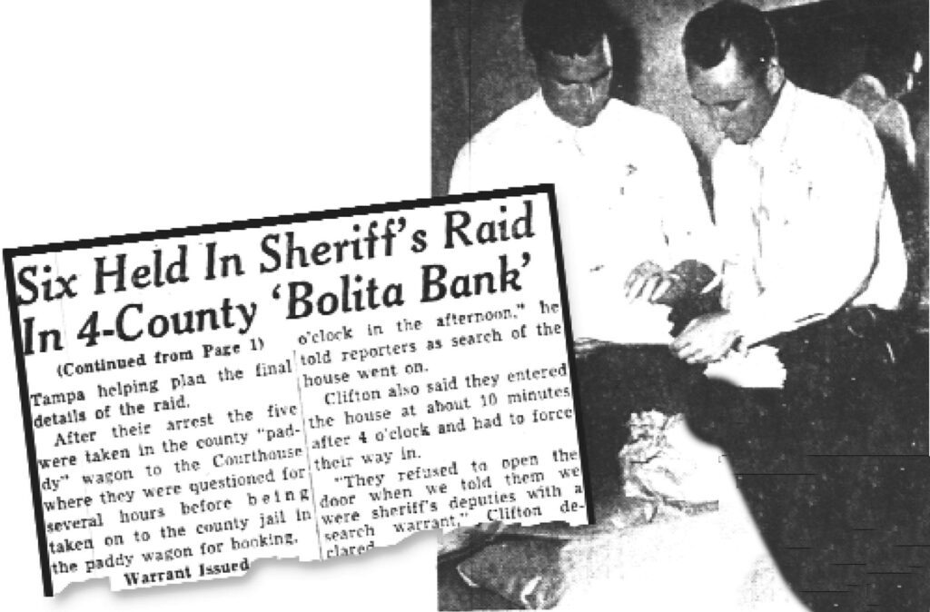 Deputy Sheriff Charlie Whitt (left) and Ellis Clifton (right), head of the county vice squad, are examining bolita tickets. They were found during a raid on a house in Gary, an industrial section located in the southeastern part of Tampa, mainly in the vicinity of Adamo Drive east of Downtown Tampa. The house was used as a four-county bolita headquarters.